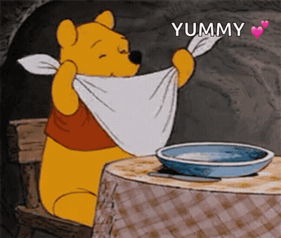Winnie The Pooh Sitting At Table With Towel Saying Yummy GIF