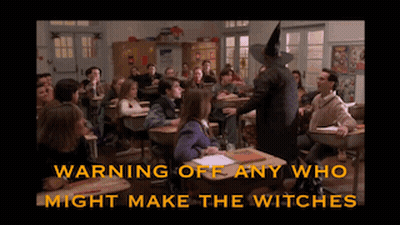 Witch Standing In Front Of Classroom Warning Off Any Who Might Make The Witches Below Her GIF
