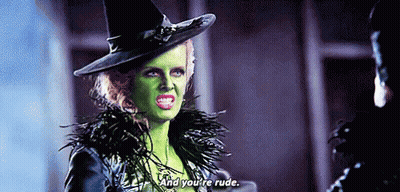 Witch With Green Face Paint Talking To Man In Hat GIF