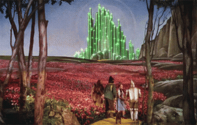 Wizard Of Oz Painting With Green Building In Distance GIF