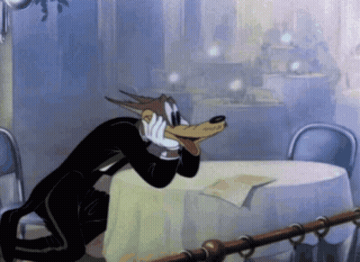 Wolf In Tuxedo Sitting At Table GIF