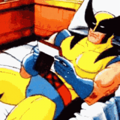 Wolverine Is Reading A Book While Laying On A Bed GIF
