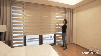Woman Adjusting Blind In Bedroom GIF