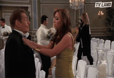 Woman Adjusting Man's Tie In Front Of TV Land Ad GIF