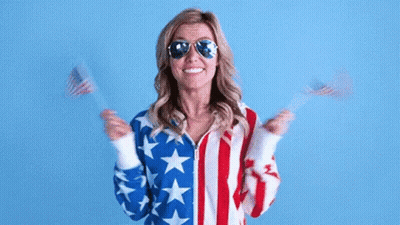 Woman American Flag Jacket Sunglasses Holding Two American Flags GIF