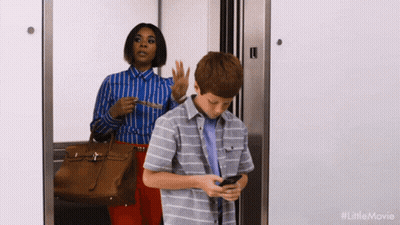 Woman And Boy In Elevator Boy Looking At Phone GIF