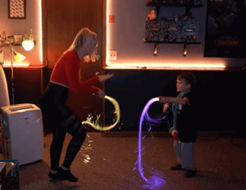 Woman And Boy Playing With Glow Toys GIF