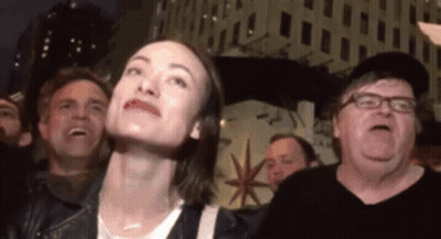 Woman And Crowd Looking Up At Sky GIF