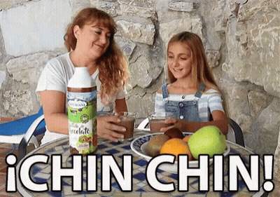 Woman And Girl Sitting At Table With Ichin Chin Bottle GIF