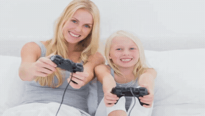 Woman And Little Girl Playing Video Game On Bed GIF