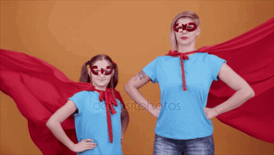 Woman And Little Girl Superhero Costumes Hands On Hips GIF