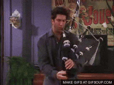 Woman And Man Sitting On Couch Looking At Camera GIF
