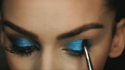 Woman Applying Blue Eye Shadow With Brush GIF