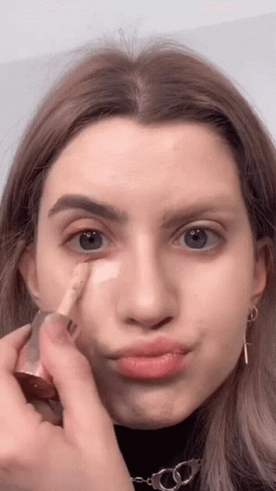Woman Applying Foundation And Making Face GIF