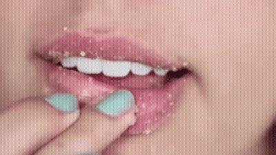 Woman Applying Lip Scrub With Finger GIF