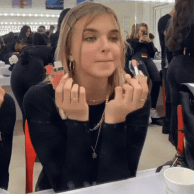 Woman Applying Lipstick In Front Of Mirror GIF