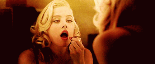 Woman Applying Lipstick In Mirror GIF