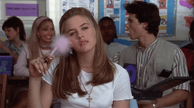 Woman Applying Makeup in Classroom While Man Eating Candy Bar