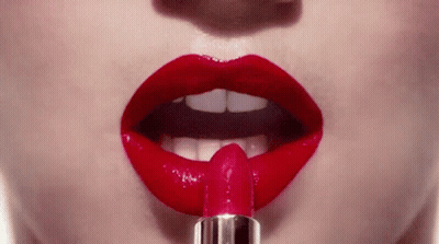 Woman Applying Red Lipstick