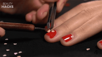 Woman Applying Red Nail Polish GIF