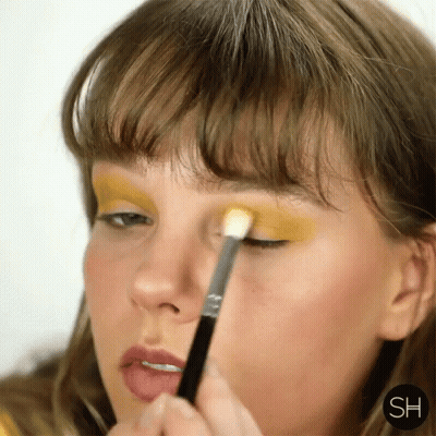 Woman Applying Yellow Eyeshadow With Brush GIF
