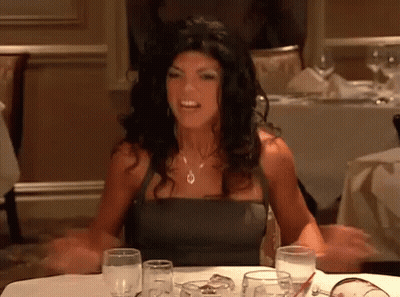Woman Arms Outstretched At Table GIF