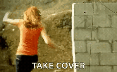 Woman Arms Outstretched Brick Wall Take Cover GIF