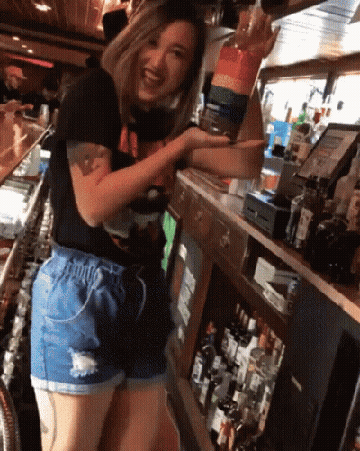 Woman At Bar With Alcohol Bottles GIF