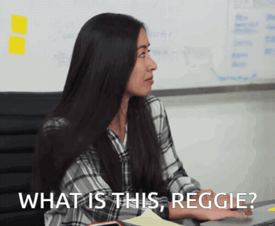 Woman At Desk Saying What Is This Reggie GIF