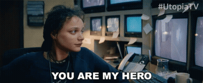 Woman At Desk Saying You Are My Hero In Front Of Monitors GIF