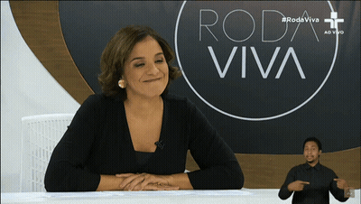 Woman At Desk With Roda Viva Sign GIF