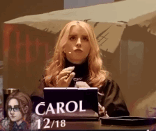 Woman At Desk With Sign Saying Carol GIF