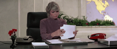 Woman At Desk With World Map GIF