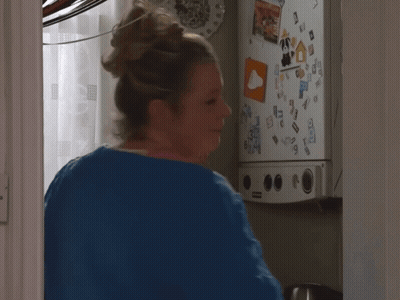 Woman At Fridge With Sticker Saying A GIF