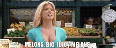 Woman at Fruit Stand With Big Juicy Melons