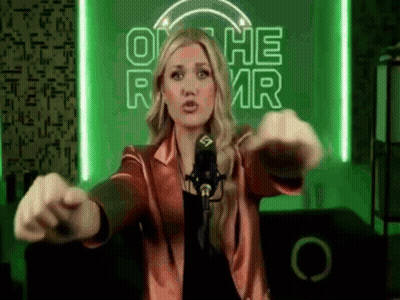 Woman At Microphone In Front Of On The RMR Neon Sign GIF