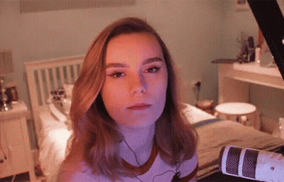 Woman At Microphone Looking At Camera GIF