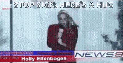 Woman At News Desk Saying Stop Sign Here's A Hug GIF