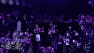 Woman At Piano With Purple Flowers GIF