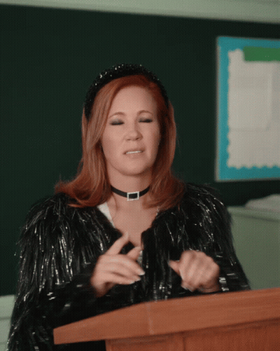Woman At Podium With Choker And Fur Coat GIF