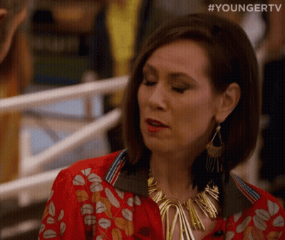 Woman At Railing Red Shirt Gold Necklace GIF