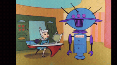 Woman At Receptionist Desk Talking To Blue Robot GIF