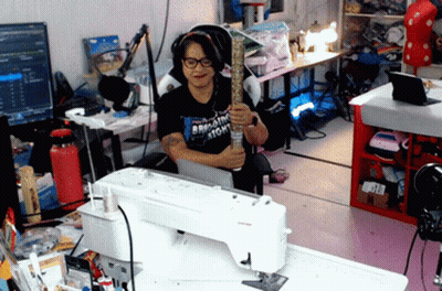 Woman at Sewing Machine Wearing Bring the Atom T-Shirt