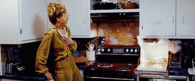 Woman At Stove With Smoke GIF