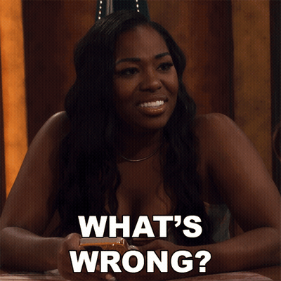 Woman At Table Saying What's Wrong GIF