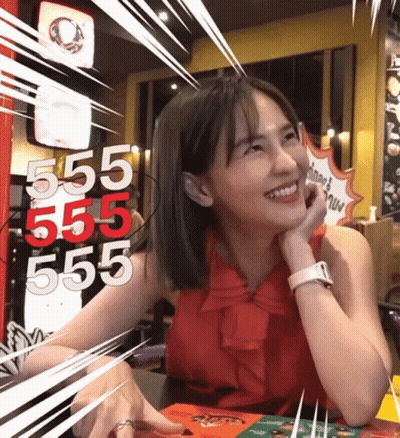 Woman At Table With 555 555 555 On Wall GIF