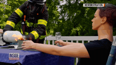 Woman At Table With Fireman Inside Edition GIF