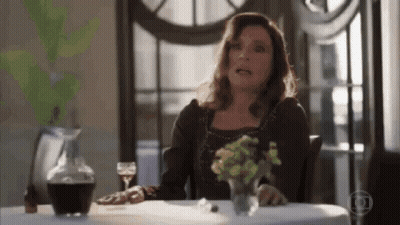 Woman At Table With Glass Of Wine GIF