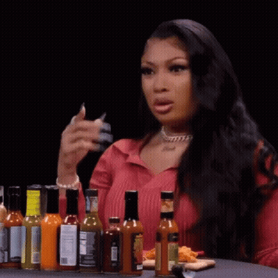 Woman At Table With Hot Sauce And Food GIF