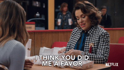 Woman At Table With Netflix Logo GIF